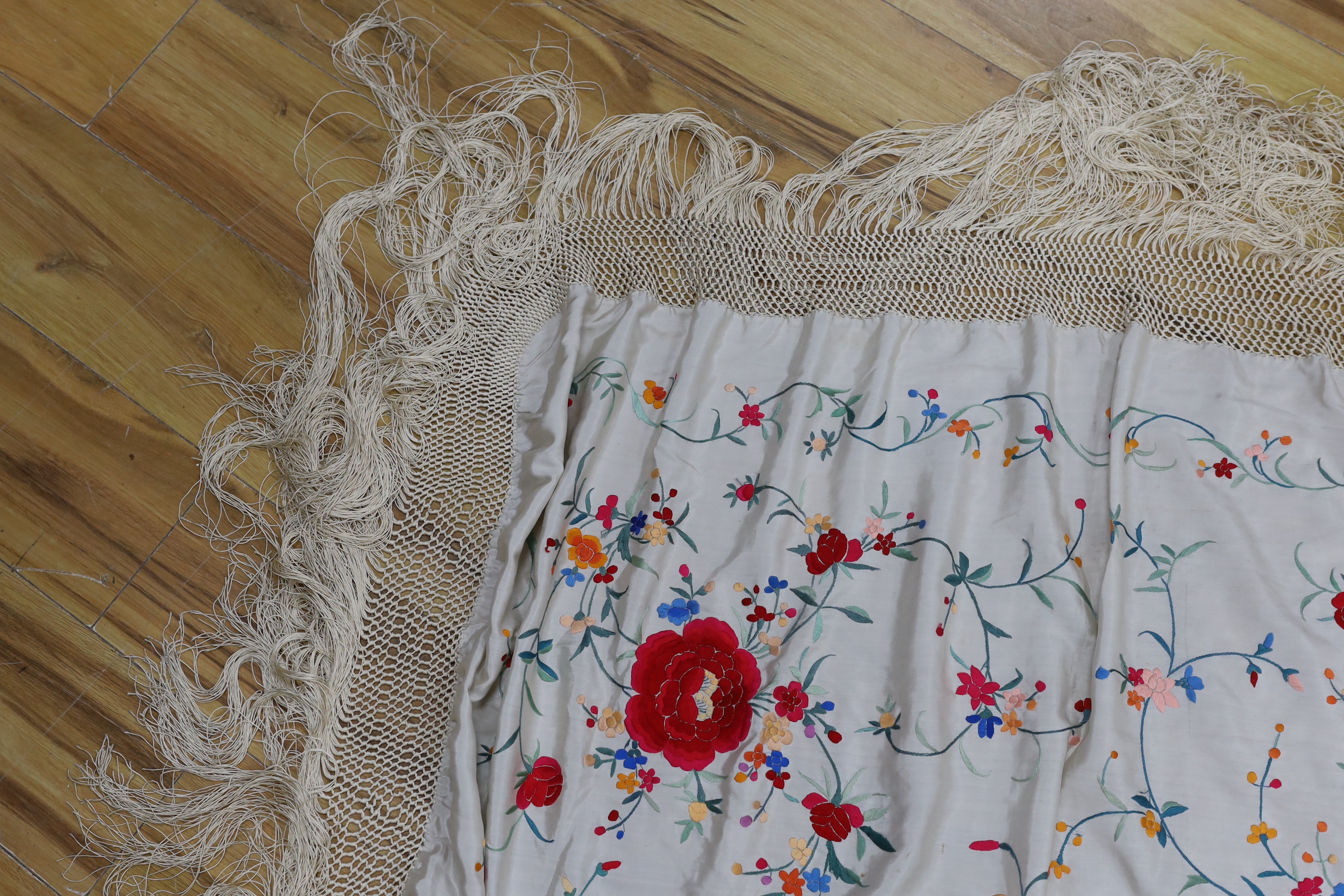 A Chinese cream silk polychrome embroidered shawl